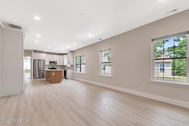31 Orleans Dr, Manchester, NJ 08759 - kitchen with appliances with stainless steel finishes, open floor plan, a center island, light wood-type flooring, and recessed lighting