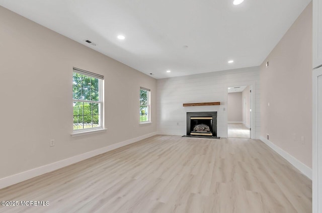31 Orleans Dr, Manchester, NJ 08759 - unfurnished living room featuring recessed lighting, light wood-style flooring, and a fireplace with flush hearth