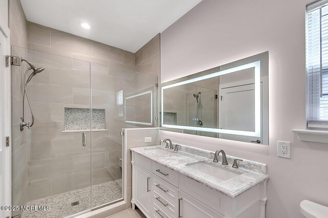 31 Orleans Dr, Manchester, NJ 08759 - bathroom featuring a shower stall, double vanity, plenty of natural light, and recessed lighting