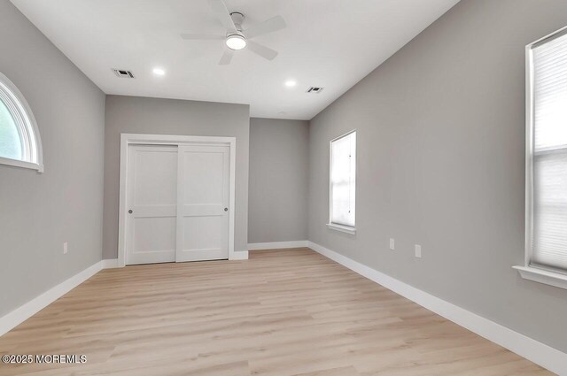 31 Orleans Dr, Manchester, NJ 08759 - unfurnished bedroom with multiple windows, light wood-style flooring, a closet, and recessed lighting