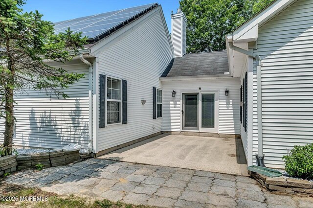 31 Orleans Dr, Manchester, NJ 08759 - back of house with a chimney, a patio, and a shingled roof