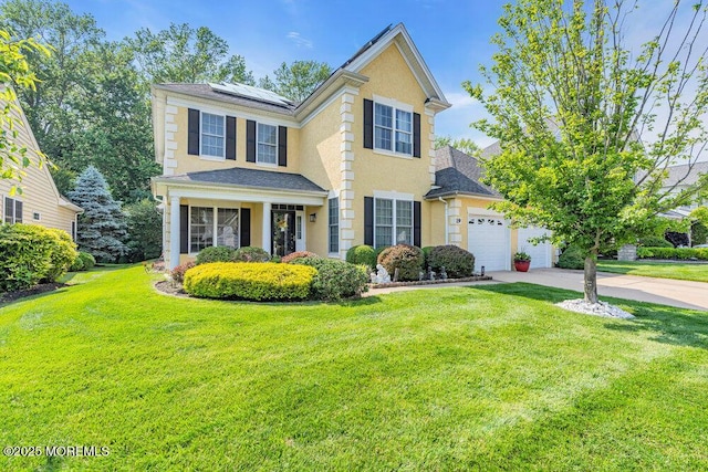 19 Carleton Dr, Freehold, NJ 07728 - traditional home with concrete driveway, a front yard, roof mounted solar panels, and a garage
