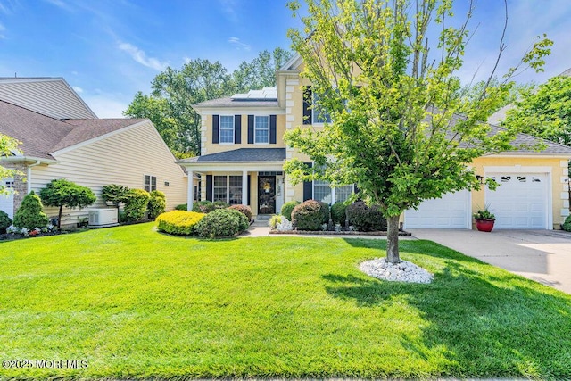 19 Carleton Dr, Freehold, NJ 07728 - view of front of property with concrete driveway, solar panels, a front lawn, and a garage