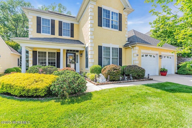 19 Carleton Dr, Freehold, NJ 07728 - view of front of property featuring driveway, a garage, a front yard, and stucco siding