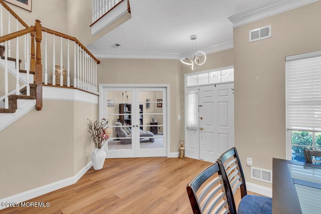 19 Carleton Dr, Freehold, NJ 07728 - foyer entrance with crown molding, wood finished floors, stairway, french doors, and a chandelier