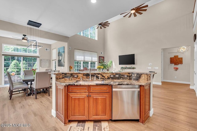 19 Carleton Dr, Freehold, NJ 07728 - kitchen featuring stainless steel dishwasher, ceiling fan, stone counters, an island with sink, and brown cabinetry