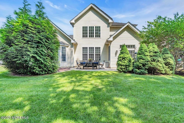 19 Carleton Dr, Freehold, NJ 07728 - rear view of house with a lawn and a patio area