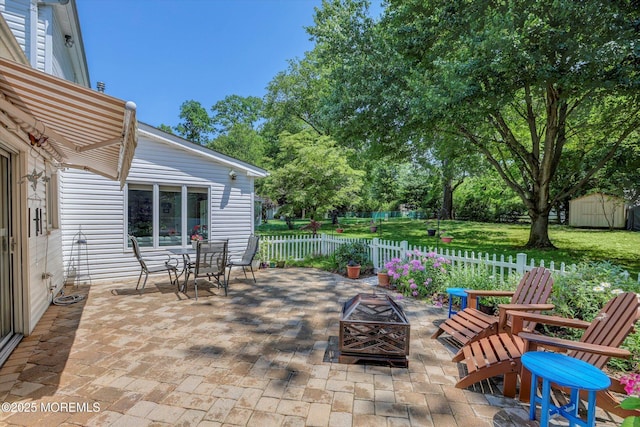 7 Owens Rd, Marlboro, NJ 07746 - view of patio with an outdoor fire pit, a storage shed, and outdoor dining space