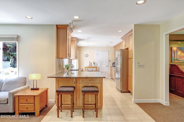 7 Owens Rd, Marlboro, NJ 07746 - kitchen featuring freestanding refrigerator, a peninsula, stone counters, recessed lighting, and a breakfast bar