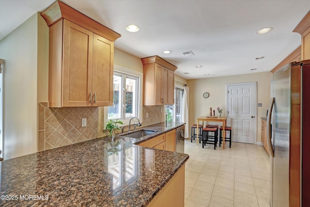 7 Owens Rd, Marlboro, NJ 07746 - kitchen with appliances with stainless steel finishes, tasteful backsplash, dark stone counters, recessed lighting, and light tile patterned floors