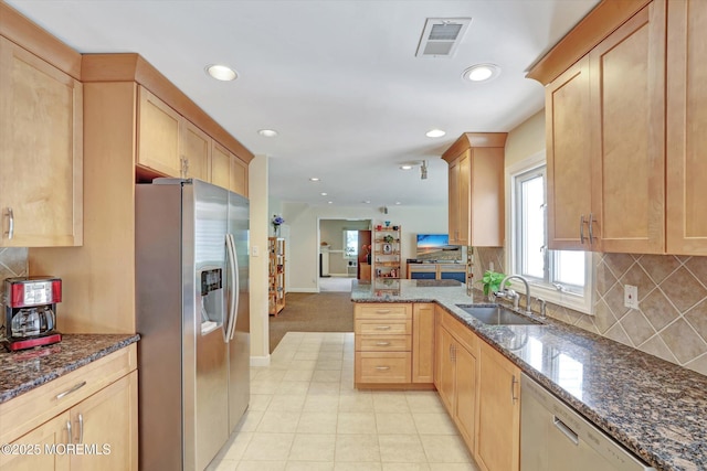 7 Owens Rd, Marlboro, NJ 07746 - kitchen with appliances with stainless steel finishes, open floor plan, a peninsula, tasteful backsplash, and dark stone counters