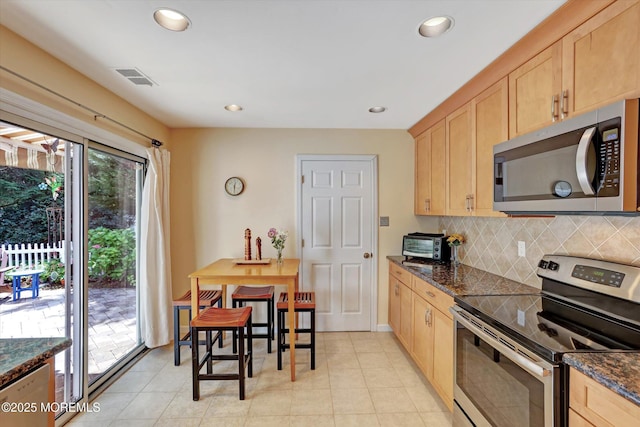 7 Owens Rd, Marlboro, NJ 07746 - kitchen featuring appliances with stainless steel finishes, light brown cabinetry, backsplash, recessed lighting, and dark stone counters