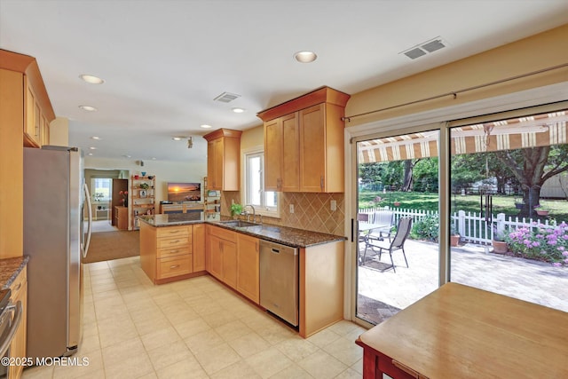 7 Owens Rd, Marlboro, NJ 07746 - kitchen with stainless steel appliances, a peninsula, dark stone countertops, backsplash, and recessed lighting