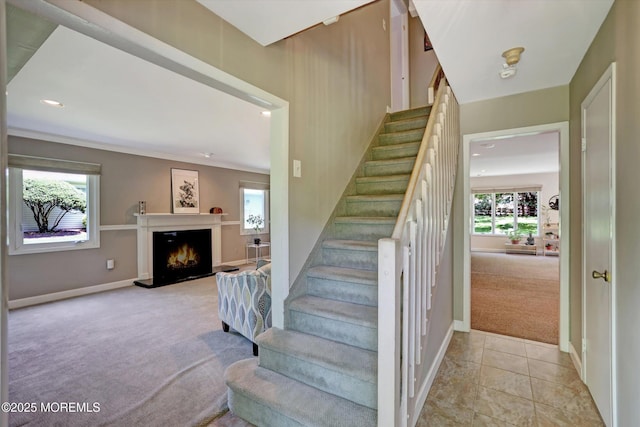 7 Owens Rd, Marlboro, NJ 07746 - stairs with carpet flooring, a warm lit fireplace, recessed lighting, and tile patterned floors