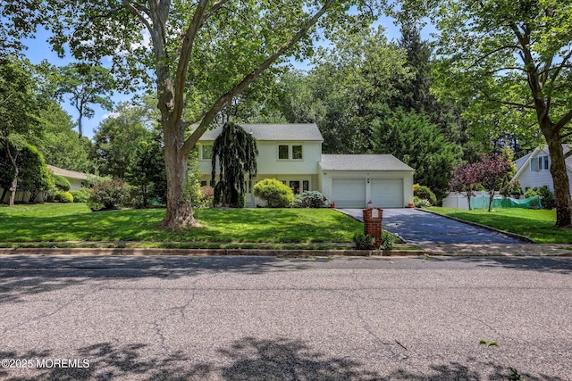 7 Owens Rd, Marlboro, NJ 07746 - view of front facade featuring an attached garage, driveway, and a front yard