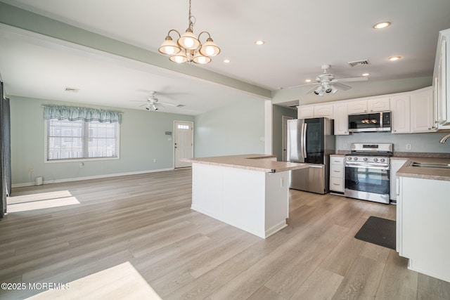 1 S Ensign Dr, Little Egg Harbor, NJ 08087 - kitchen with appliances with stainless steel finishes, ceiling fan, light wood-style flooring, white cabinetry, and recessed lighting