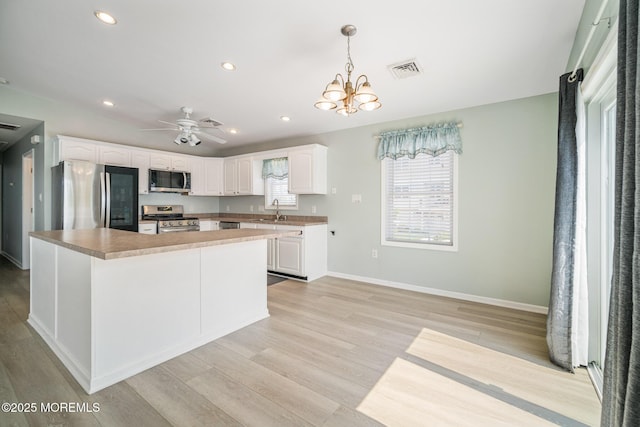 1 S Ensign Dr, Little Egg Harbor, NJ 08087 - kitchen with stainless steel appliances, white cabinetry, light wood finished floors, and recessed lighting