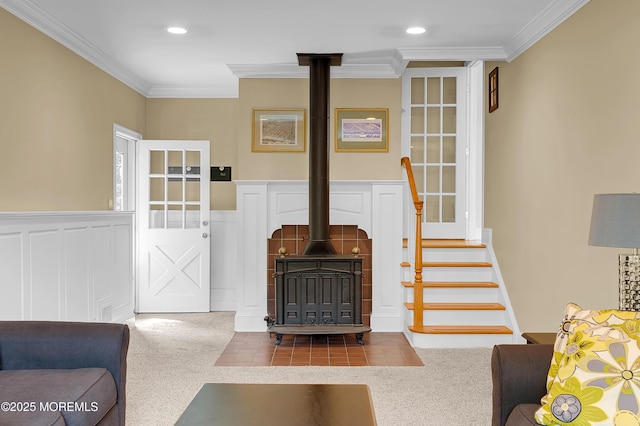 4607 Broad St, Wall, NJ 07753 - living area featuring crown molding, a wood stove, wainscoting, recessed lighting, and stairway