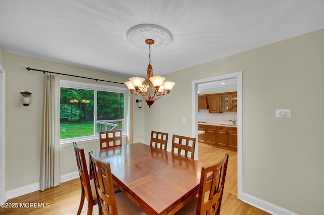 4607 Broad St, Wall, NJ 07753 - dining room with light wood-style flooring and a chandelier