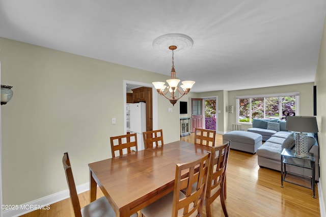 4607 Broad St, Wall, NJ 07753 - dining room with a chandelier and light wood-style flooring
