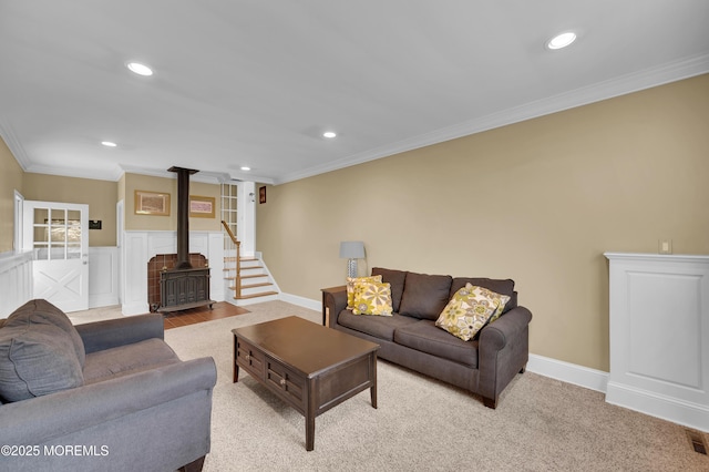 4607 Broad St, Wall, NJ 07753 - living area featuring crown molding, recessed lighting, a wood stove, carpet, and stairway