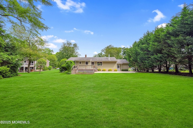 4607 Broad St, Wall, NJ 07753 - view of grassy yard featuring a deck