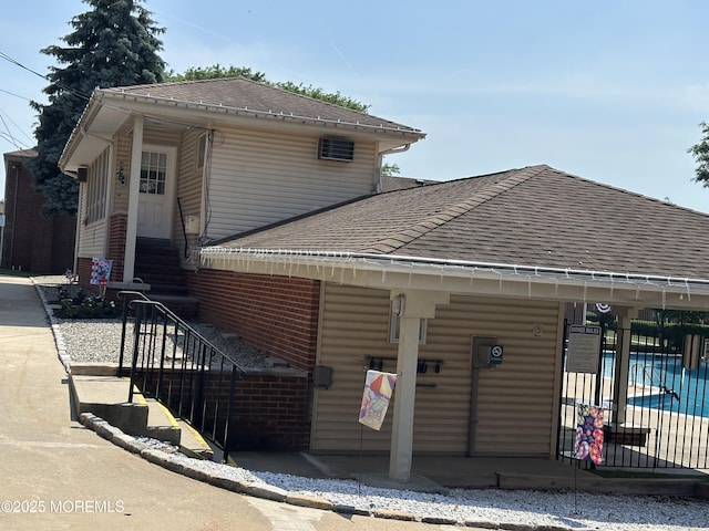 66 Fox Rd Unit 10A, Edison, NJ 08817 - view of front of property with roof with shingles, a community pool, stairway, and brick siding