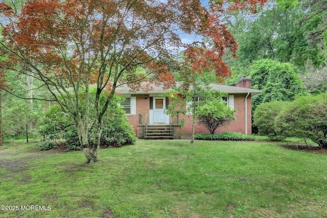 192 Crescent Ave, Jackson, NJ 08527 - view of front of house with brick siding, a chimney, and a front lawn