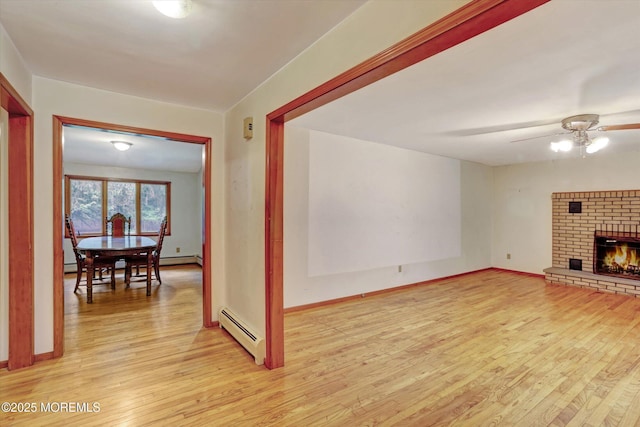 192 Crescent Ave, Jackson, NJ 08527 - unfurnished living room featuring baseboard heating, light wood-style flooring, a ceiling fan, and a brick fireplace