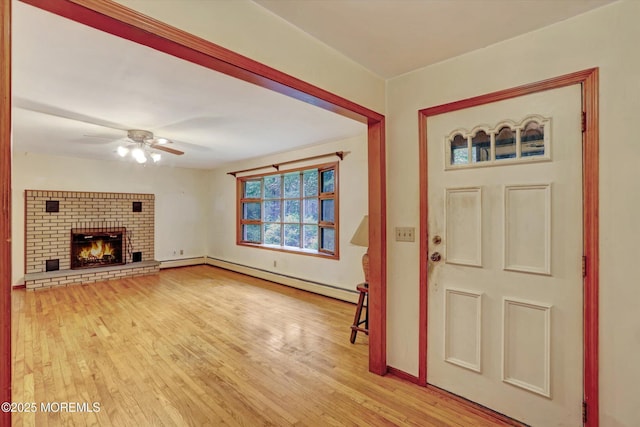 192 Crescent Ave, Jackson, NJ 08527 - entrance foyer featuring a baseboard heating unit, wood finished floors, ceiling fan, and a brick fireplace