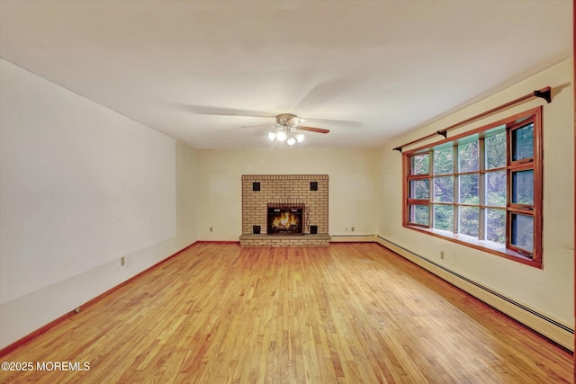 192 Crescent Ave, Jackson, NJ 08527 - unfurnished living room featuring baseboard heating, light wood-style floors, a ceiling fan, and a brick fireplace