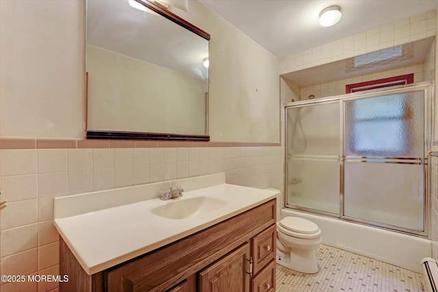 192 Crescent Ave, Jackson, NJ 08527 - bathroom featuring tile walls, vanity, a baseboard heating unit, combined bath / shower with glass door, and tile patterned flooring
