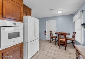 1263 Hamilton Ct Unit B, Lakewood, NJ 08701 - kitchen featuring white appliances, brown cabinets, light tile patterned flooring, and light countertops
