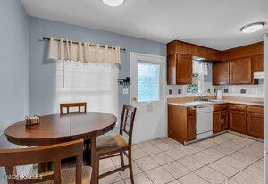 1263 Hamilton Ct Unit B, Lakewood, NJ 08701 - kitchen featuring dishwasher, brown cabinets, light countertops, and light tile patterned flooring