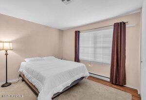 1263 Hamilton Ct Unit B, Lakewood, NJ 08701 - bedroom featuring wood finished floors and a baseboard heating unit