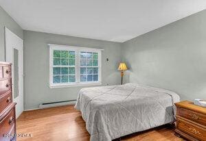 1263 Hamilton Ct Unit B, Lakewood, NJ 08701 - bedroom with a baseboard radiator and wood finished floors