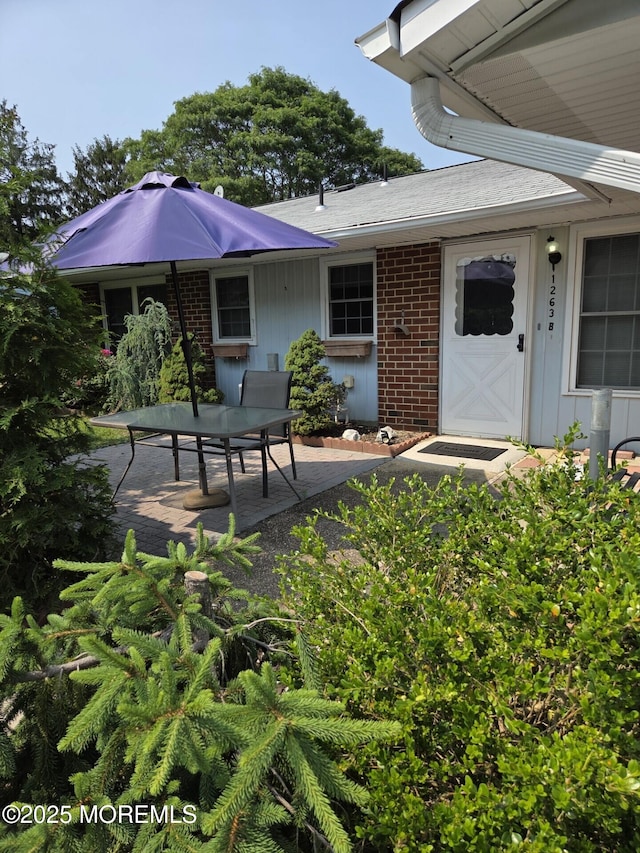 1263 Hamilton Ct Unit B, Lakewood, NJ 08701 - view of exterior entry with a patio area and brick siding