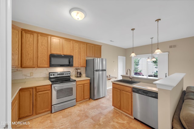 52 Country Walk Blvd, Whiting, NJ 08759 - kitchen featuring appliances with stainless steel finishes, light countertops, decorative light fixtures, open floor plan, and a center island with sink