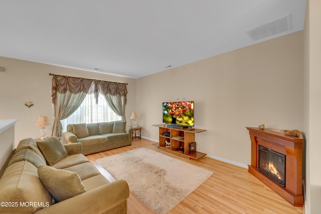 52 Country Walk Blvd, Whiting, NJ 08759 - living area featuring light wood-type flooring and a glass covered fireplace