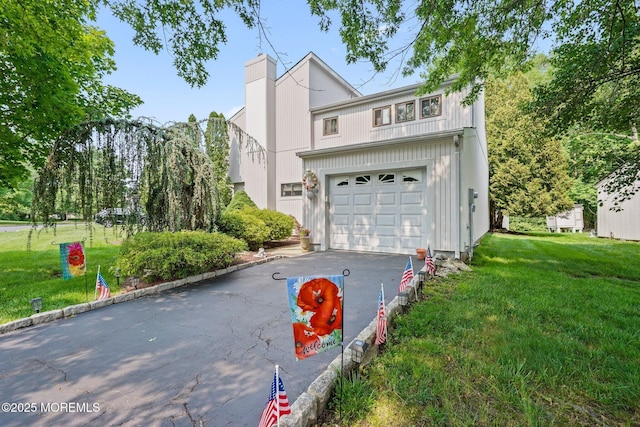 236 Community Cir, Old Bridge, NJ 08857 - view of front of home featuring a garage, driveway, a chimney, and a front lawn