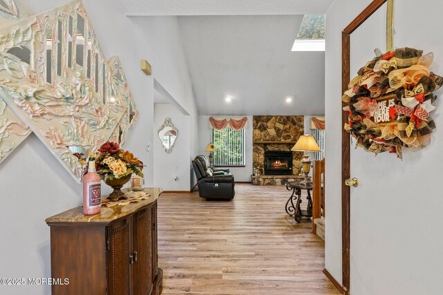 236 Community Cir, Old Bridge, NJ 08857 - foyer entrance with light wood-type flooring, a skylight, a stone fireplace, high vaulted ceiling, and recessed lighting