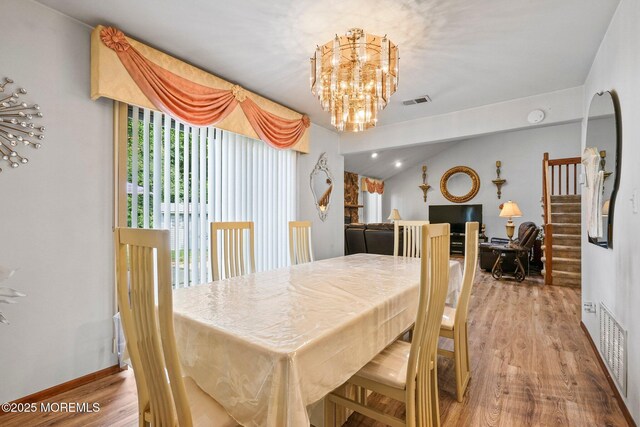 236 Community Cir, Old Bridge, NJ 08857 - dining area featuring wood finished floors, a chandelier, stairway, and lofted ceiling