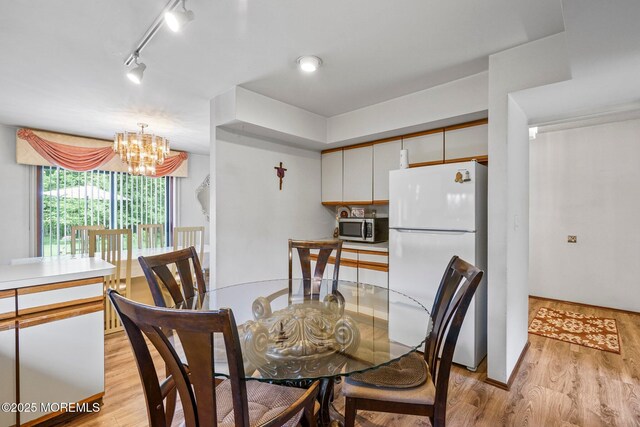 236 Community Cir, Old Bridge, NJ 08857 - dining room featuring a chandelier and light wood-style floors