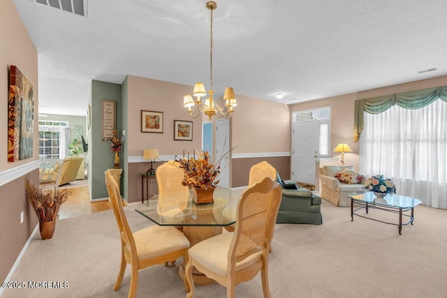 44 Autumntide Dr, Lakewood, NJ 08701 - dining area featuring light colored carpet and a chandelier