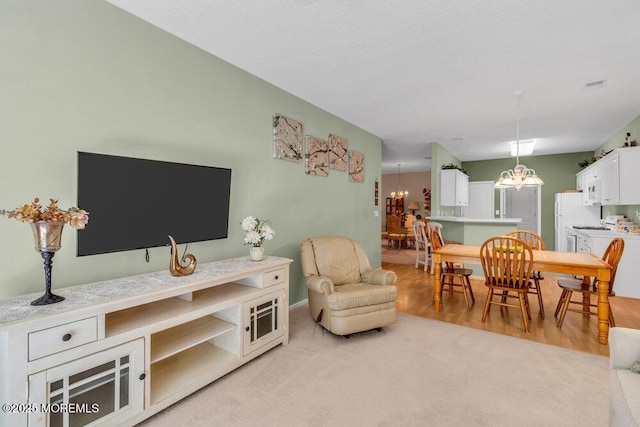 44 Autumntide Dr, Lakewood, NJ 08701 - living room with a chandelier and light wood-style floors