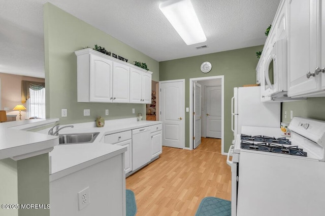 44 Autumntide Dr, Lakewood, NJ 08701 - kitchen with white appliances, white cabinetry, light wood-style flooring, a peninsula, and a textured ceiling