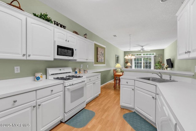 44 Autumntide Dr, Lakewood, NJ 08701 - kitchen featuring white appliances, white cabinets, light countertops, light wood-style flooring, and ceiling fan