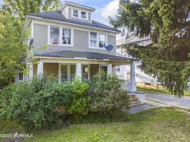 53 Broadway Rd, Freehold, NJ 07728 - traditional style home with covered porch, roof with shingles, and a front yard