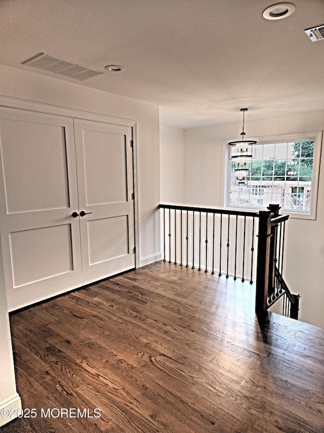 413B Lake Shr, Brick, NJ 08723 - empty room with dark wood-type flooring, recessed lighting, and a chandelier
