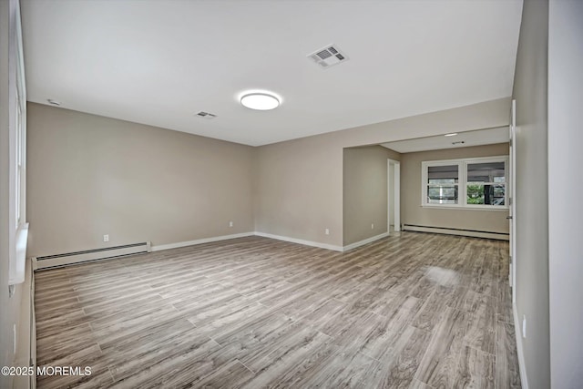 48 Sheepshead Dr, Toms River, NJ 08757 - empty room with a baseboard heating unit and light wood-style flooring